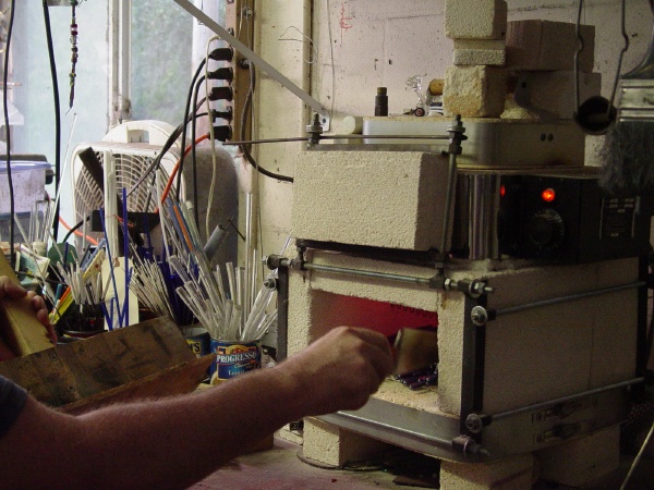 Straightening out the glass furnace bead glass canes in the kiln/annealer